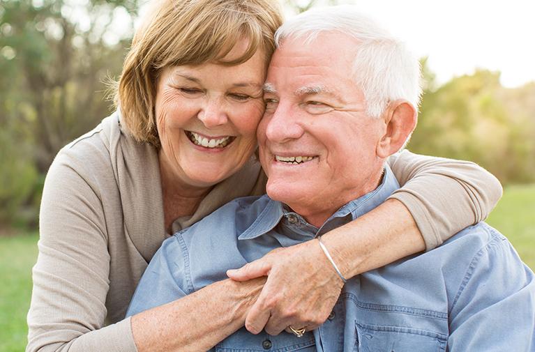 Woman embracing a man both smiling 